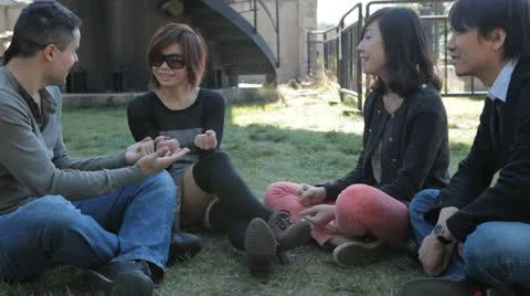 Group of Four Friends Having Fun Playing Hand-Slapping Game Stock Footage 22223138