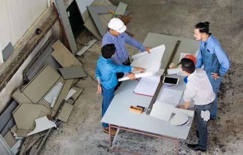 Group of four people including engineer and businessmen discuss and review ab Stock Photos