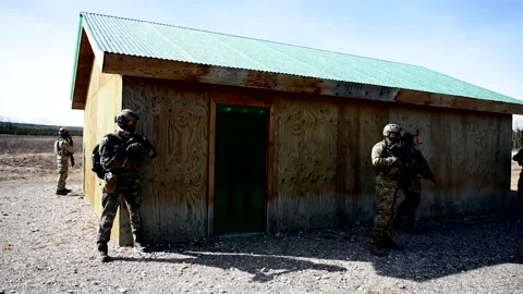 Group of Four Soldiers Guarding a Small Building Stock Footage 130357802