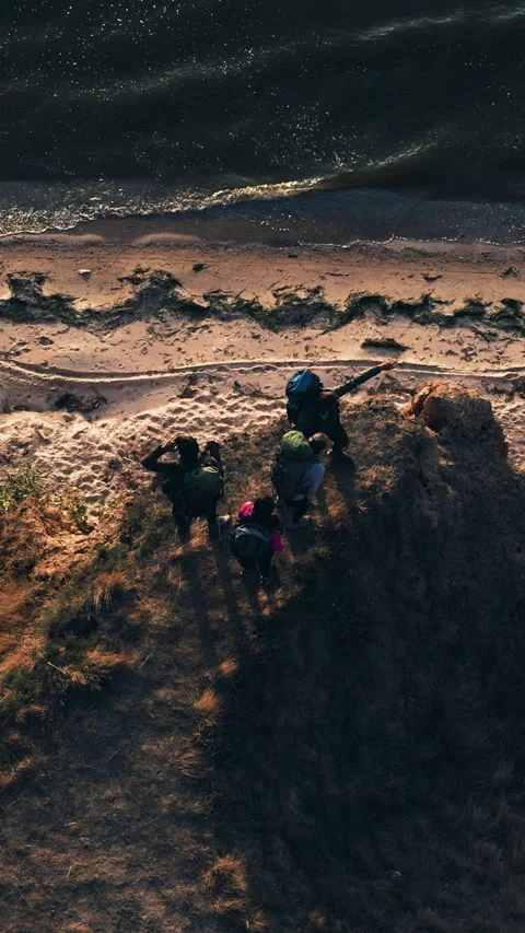 The group of four standing on the mountain top above the sea Stock Footage 242134050