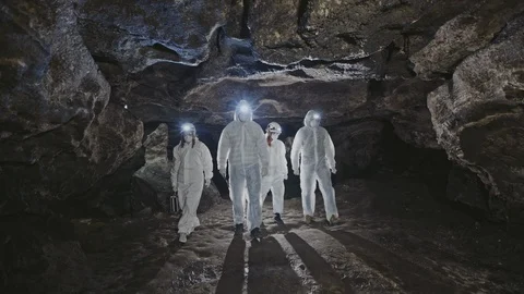 A group of four white-explorers exploring the cave 動画素材 106413035