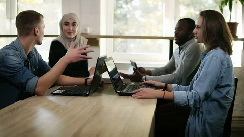 Group of four young mixed race and cultural people - muslim woman, african man 스톡 동영상 99584655