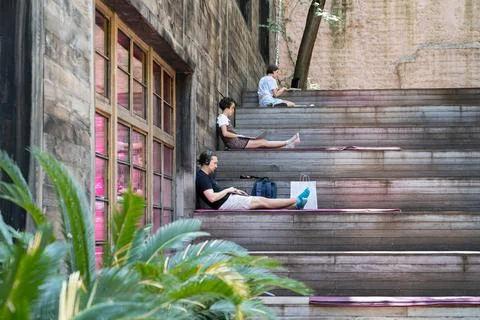Group of freelancer work on laptop remotely or study in outdoor coworking space Stock Photos