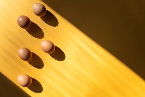 Group of fresh eggs on the table isolated on yellow background. 스톡 사진