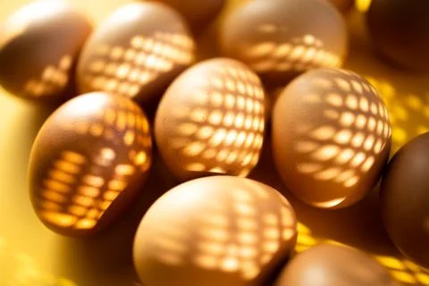 Group of fresh eggs on the table isolated on yellow background. Easter concep 스톡 사진