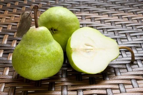 Group Of Fresh Pears With One Halved Stock Photos