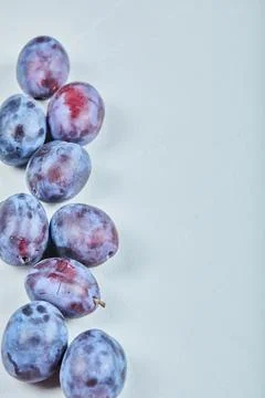Group of fresh plums on a blue background Stock Photos