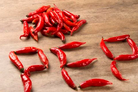 Group of fresh red hot peppers on a wooden table Stock Photos