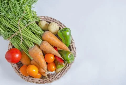 A group of fresh vegetables on a light background. Stock Photos