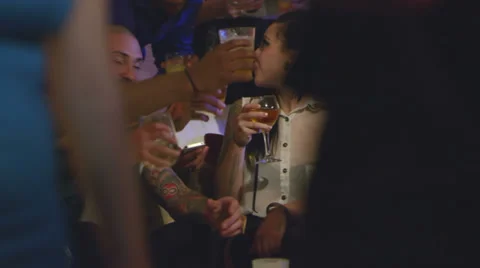 A group of friends all cheers each other while at a house party Stock Footage 34016229