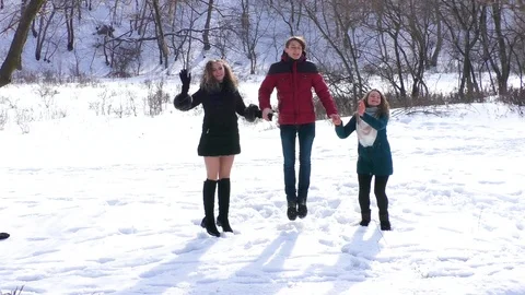 Group of friends are bouncing up holding hands Stock Footage 94562797