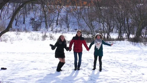 Group of friends are bouncing up holding hands 스톡 동영상 94562812