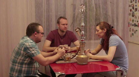 A group of friends are talking and smoking hookah Stock Footage 59571324