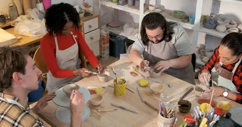 Group of friends attending pottery class having fun making clay objects tog.. Stock Footage 345207325
