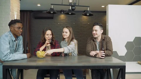 Group of friends awaiting pizza at a table at home. Friendship and party concept Stock Footage 124048503