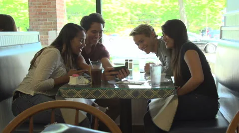 A group of friends bond over a cell phone. Stock Footage 44116408