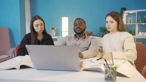 Group of friends brainstorming about a problem on laptop. Stock Footage 228803494