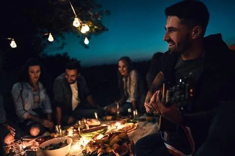 Group of friends camping, enjoy the night with guitar a sing a song Stock Photos