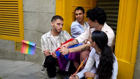 Group of friends celebrating pride month with rainbow flag Stock Footage 318828291