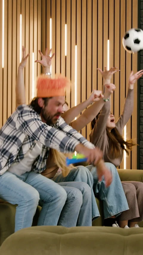 Group of friends celebrating while watching a soccer game, with one person Stock-Footage 332014808