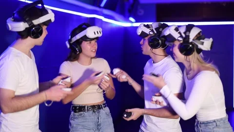 Group of friends chat animatedly after playing virtual reality Stock Footage 323069480