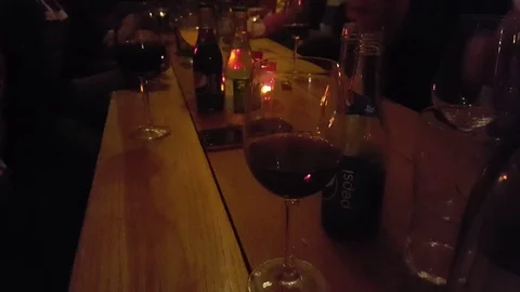 Group of friends chatting talking drinking wine in a pub bar Stock Footage 69931847