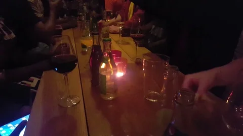 Group of friends chatting talking drinking using mobile phones in a pub bar Stock Footage 69932306