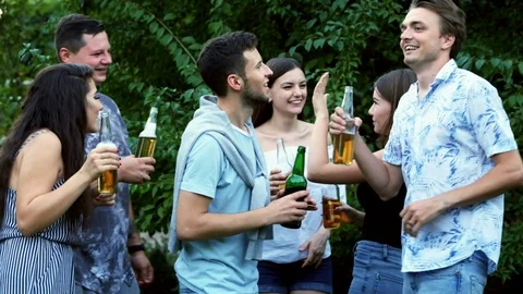 Group of friends dance and talking, people drink beer outdoors in the park Stock Footage 114220355