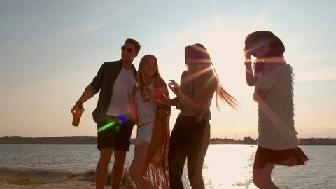 Group of friends dancing and celebrating on beach Stock Footage 80492223