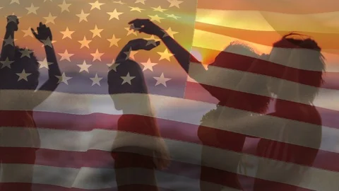 Group of friends dancing in the beach and an American flag for fourth of July. Stock Footage 111040466