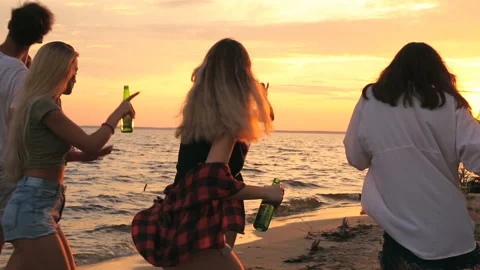 Group of friends dancing on the beach. Sunset time. Stock Footage 93539743
