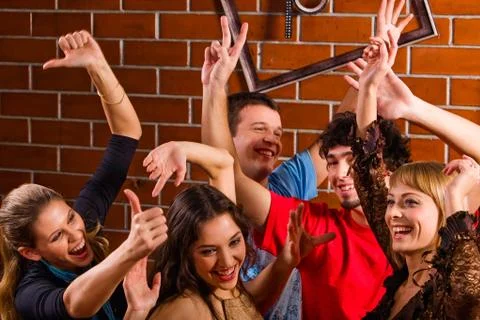 Group of friends dancing at a night club Stock Photos