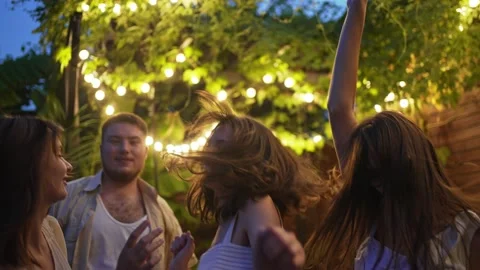 A group of friends dancing outside at a party. Celebrating and fan at the Stock Footage 164035515