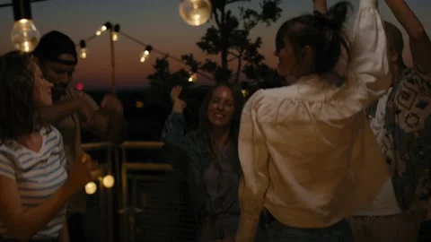 Group of friends dancing at the party in top of the roof at night Stock-Footage 203997771