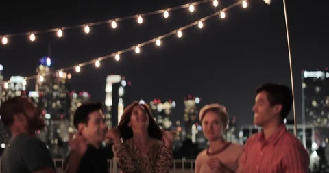 Group of friends dancing at a rooftop party Stock Footage 99393876