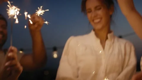 Group friends dancing together at the rooftop with sparkles Stock Footage 203956788