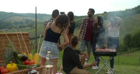 Group of friends doing a bbq in the countryside together. shot in slow motion Stock Footage 92467150