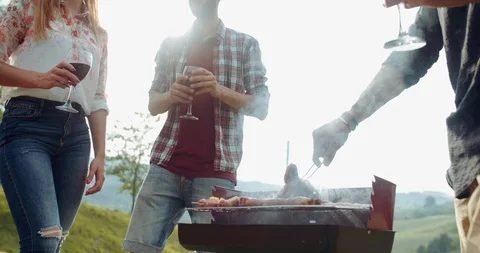 Group of friends doing a bbq in the countryside together. shot in slow motion Stock Footage 92467435
