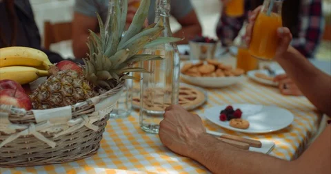 Group of friends doing breakfast outdoors in a traditional countryside. shot in Stock Footage 92023402