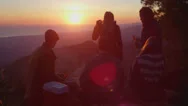 A Group Of Friends Drink Beer At A Campsite As The Sun Sets. Stock Footage