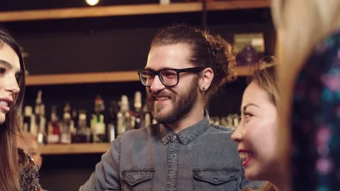 Group of friends drinking beer, chatting and having good time at pub. Night out. Stock Footage 125085908