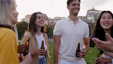 Group of friends drinking beer having fun in a party at the park. Having fun in Stock Footage 264984534