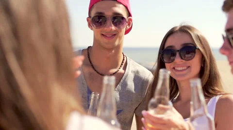 Group of friends drinks beer or cider at beach. Radial close up shot Stock Footage 67349168