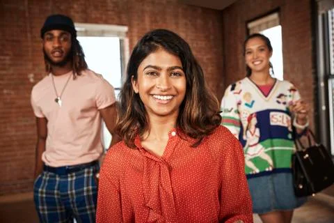 Group of friends in empty loft space, socially distanced group photo focus on Stock Photos