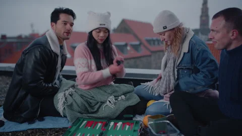 Group Of Friends Enjoy A Game Of Backgammon On A Rooftop Stock Footage 282916667