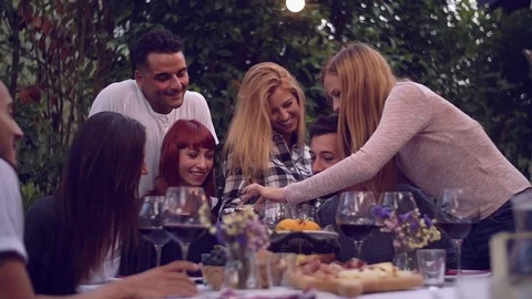 Group of friends enjoying together at a dinner party Stock Footage