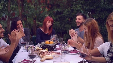 Group of friends enjoying together at a dinner party Stock Footage