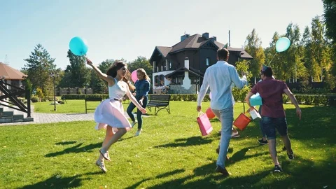 The group of friends with a festive dance around the birthday boy Stock Footage 80620334