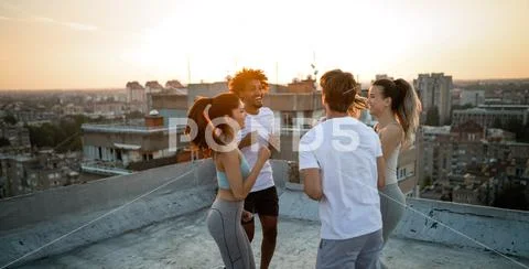 Group of friends fitness training together outdoors living active healthy Stock Photos
