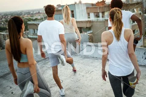 Group of friends fitness training together outdoors living active healthy Stock Photos